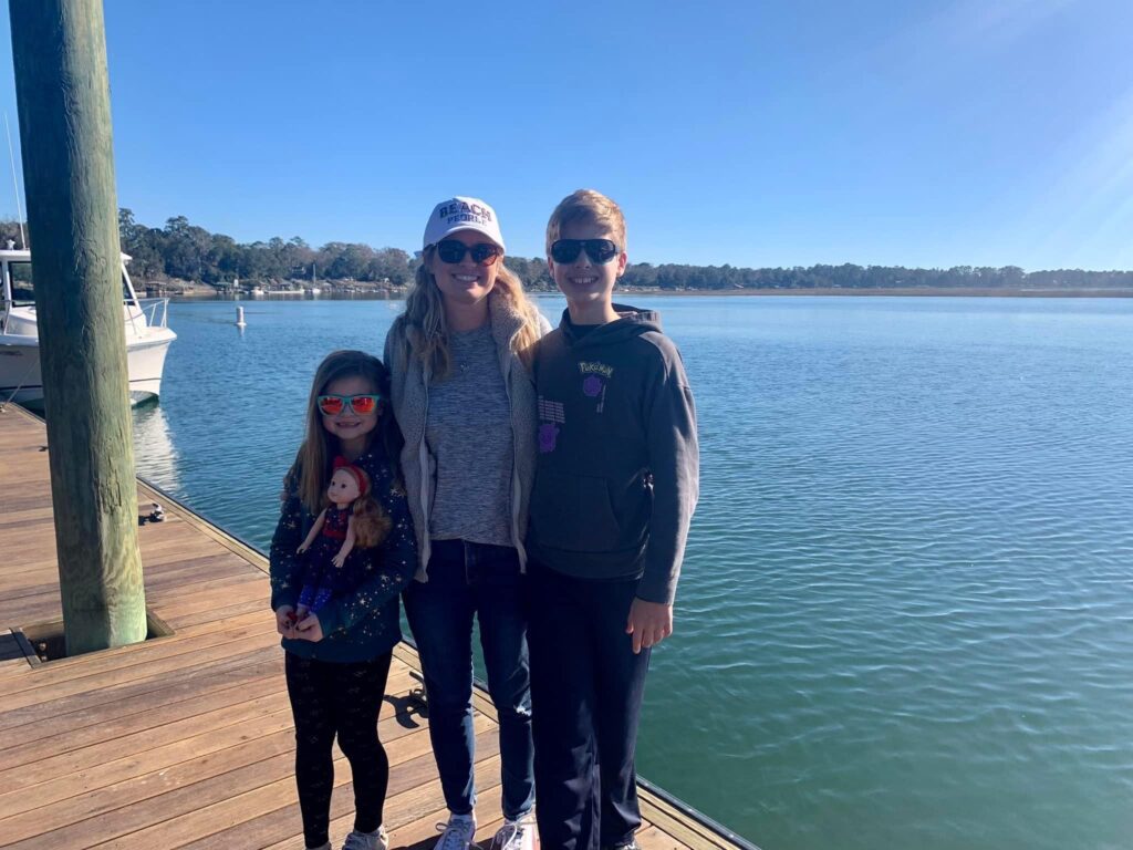 Amanda and kids on dock in front of water