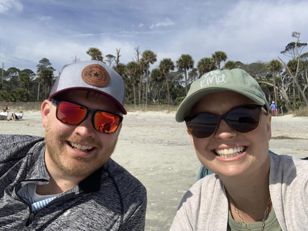brother and sister smiling for camera on beach