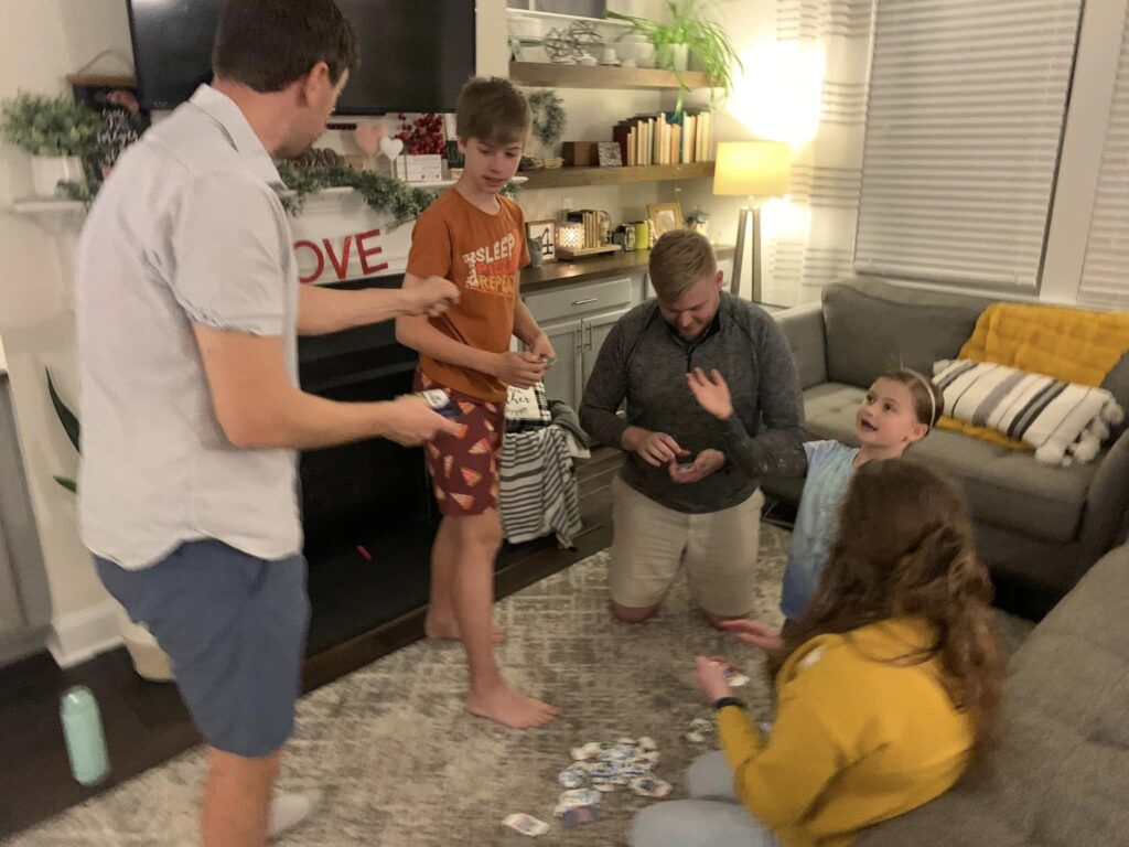 Group of people playing board game in living room