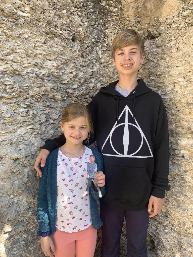kids stand in corner of old ruins smiling