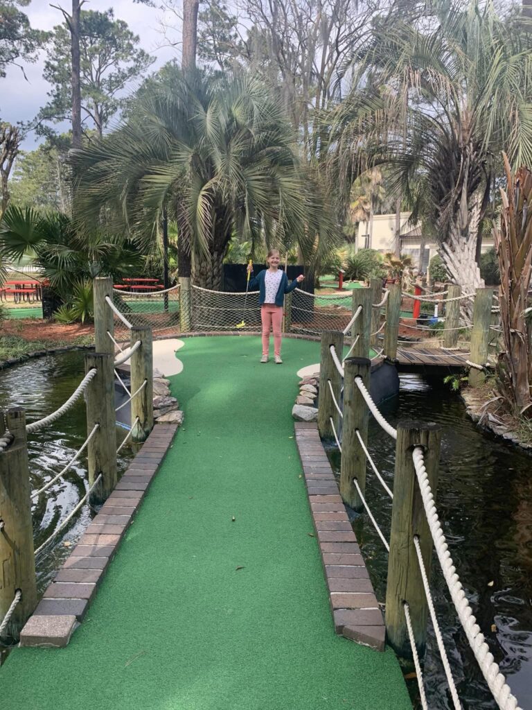 girl celebrates after getting a hole in one